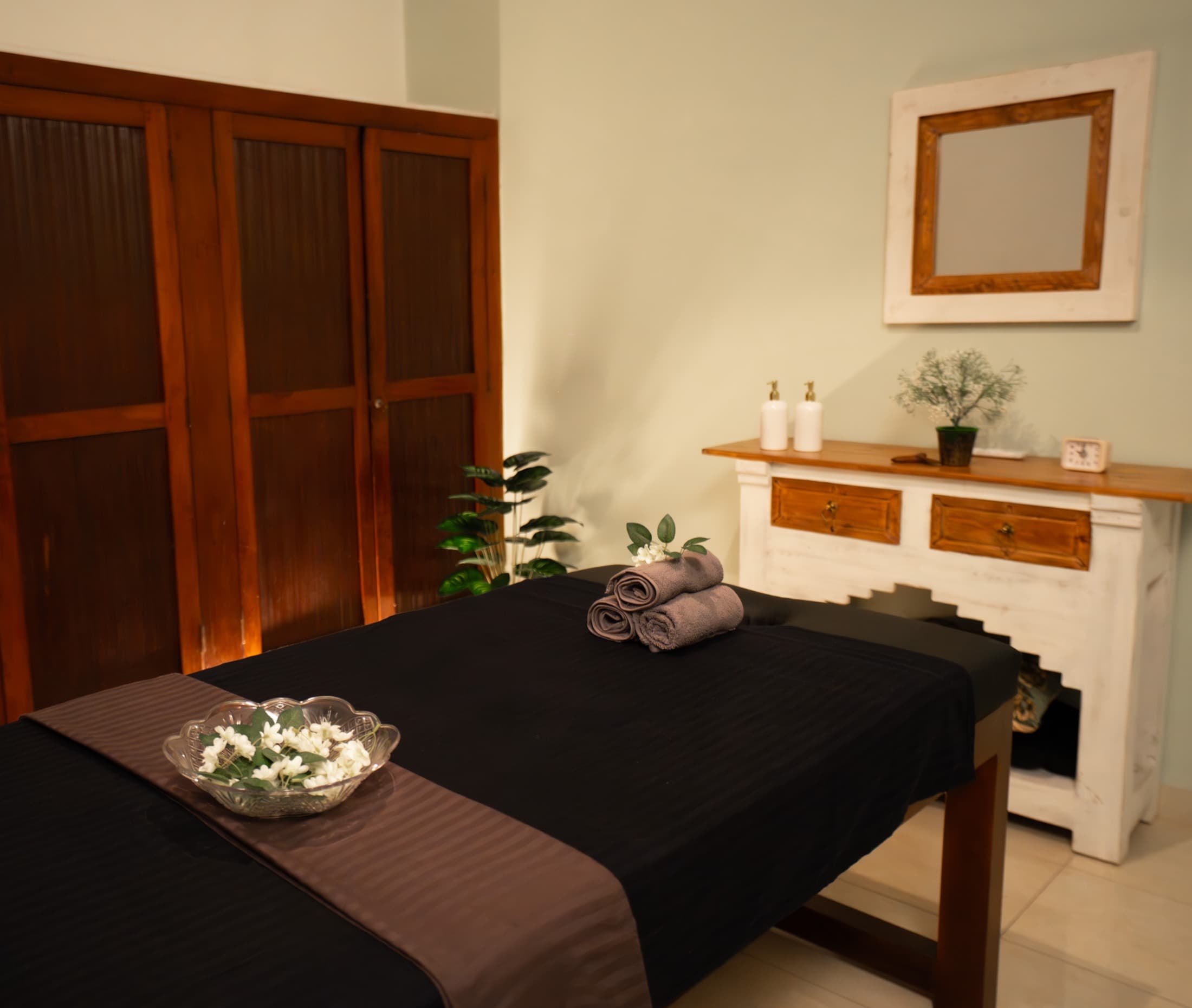 Therapist preparing a serene Balinese massage session at Healing Bliss